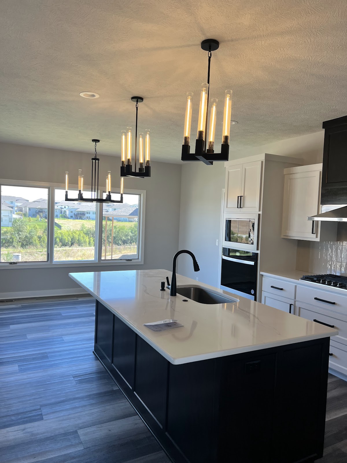 Kitchen remodel with warm shaker cabinets, stone countertops, and tile backsplash in Lake County Ohio