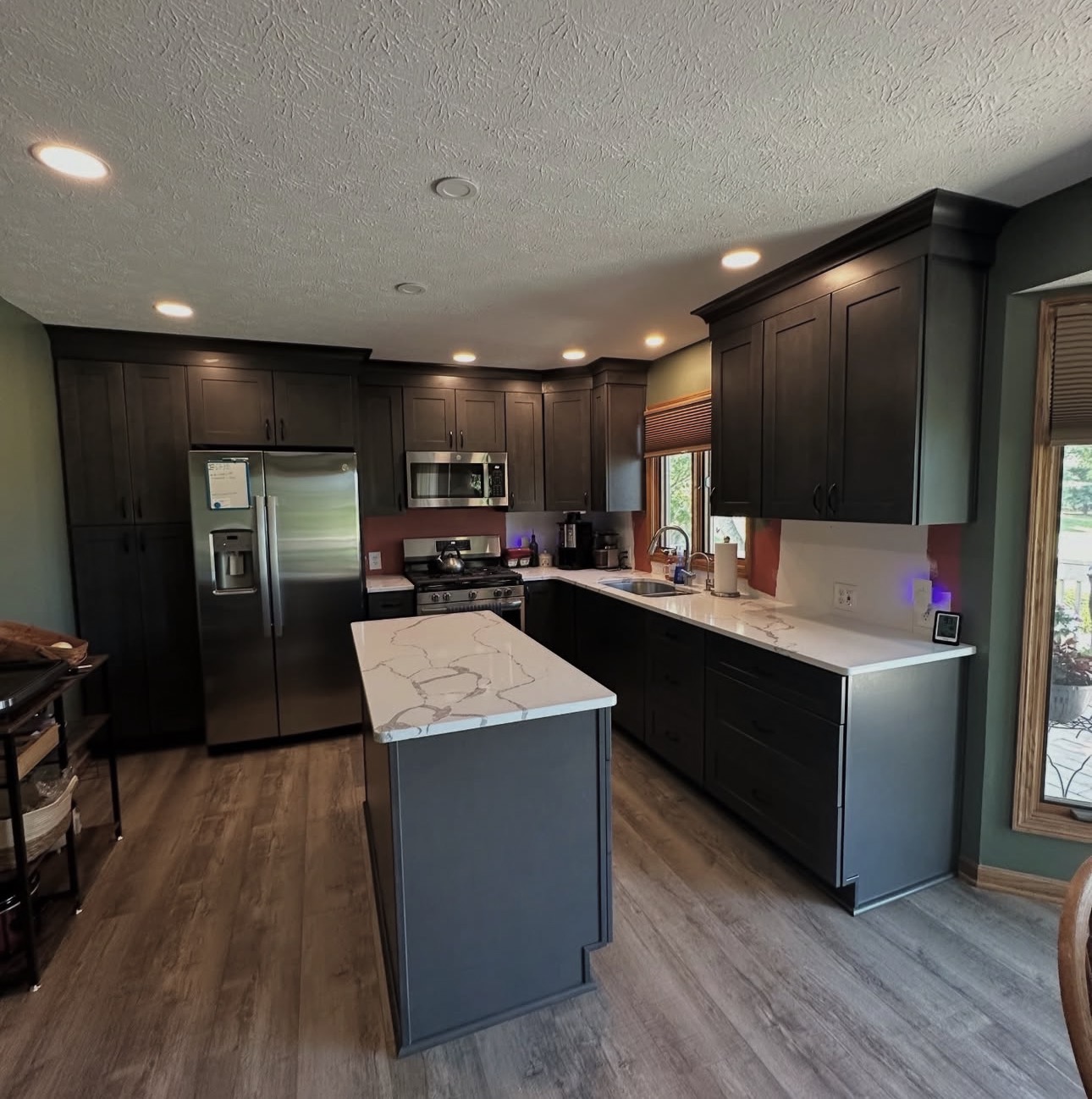 Kitchen remodel with white cabinets, quartz countertops, and tile backsplash in Cuyahoga County