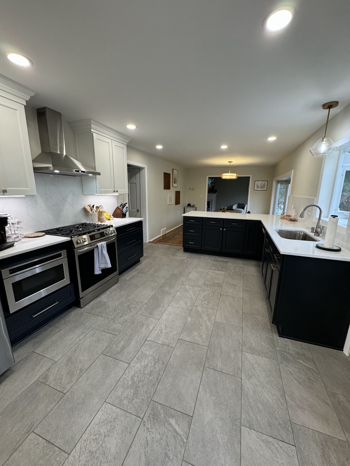 Kitchen renovation with white shaker cabinets, quartz countertops, and tile backsplash in Northeast Ohio