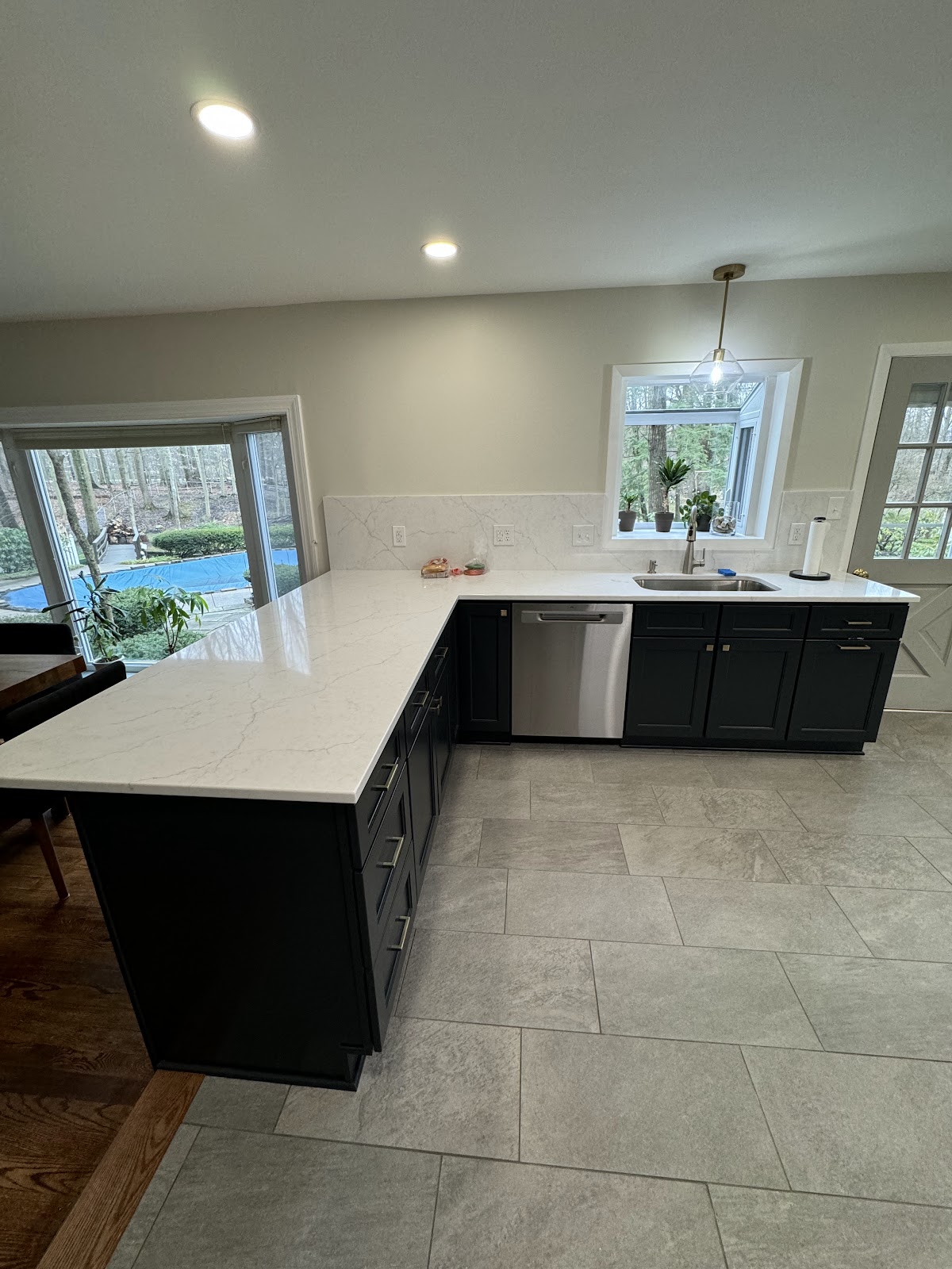 Full kitchen renovation with updated shaker cabinets, stone countertops, and tile backsplash in Northeast Ohio
