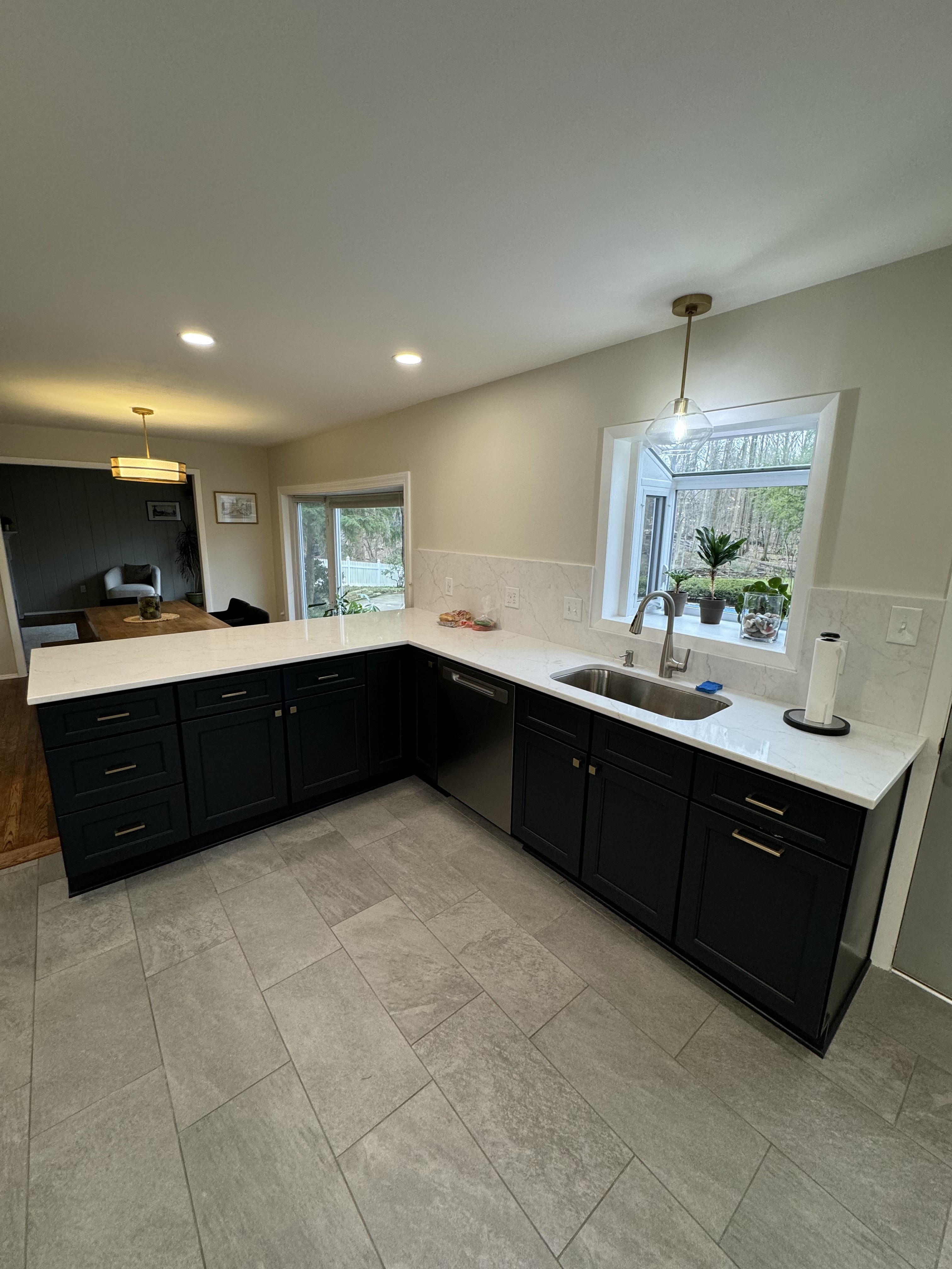 Kitchen remodel with custom cabinetry, granite countertops, and new flooring in Lake County Ohio