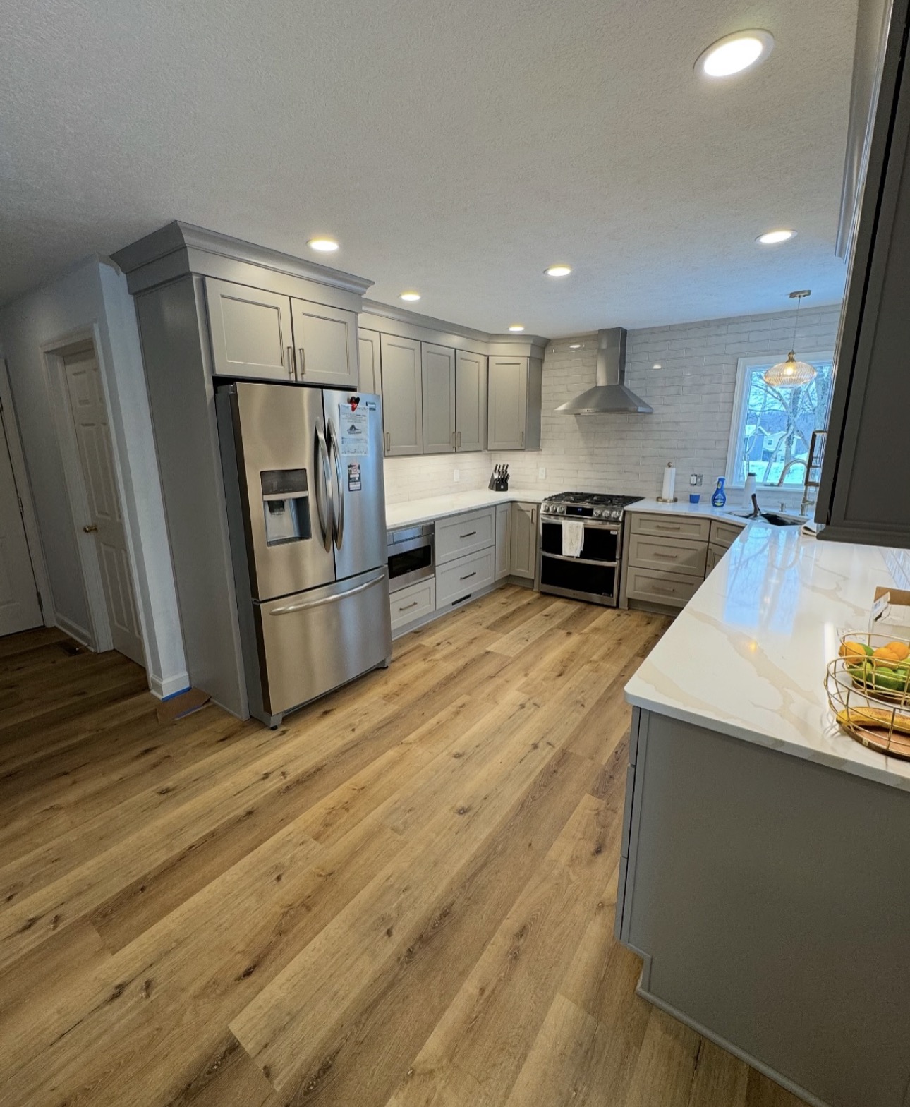 Kitchen remodel with custom cabinetry, premium countertops, and tile backsplash in Lake County Ohio