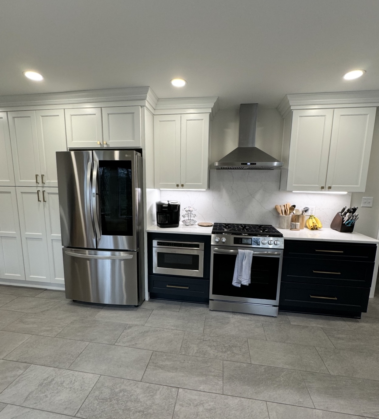 Kitchen remodel with custom cabinetry, stone countertops, and tile backsplash in Lake County Ohio