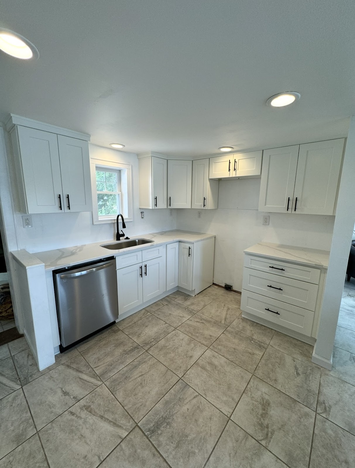 Full kitchen renovation with custom cabinetry, stone countertops, and new flooring in Northeast Ohio