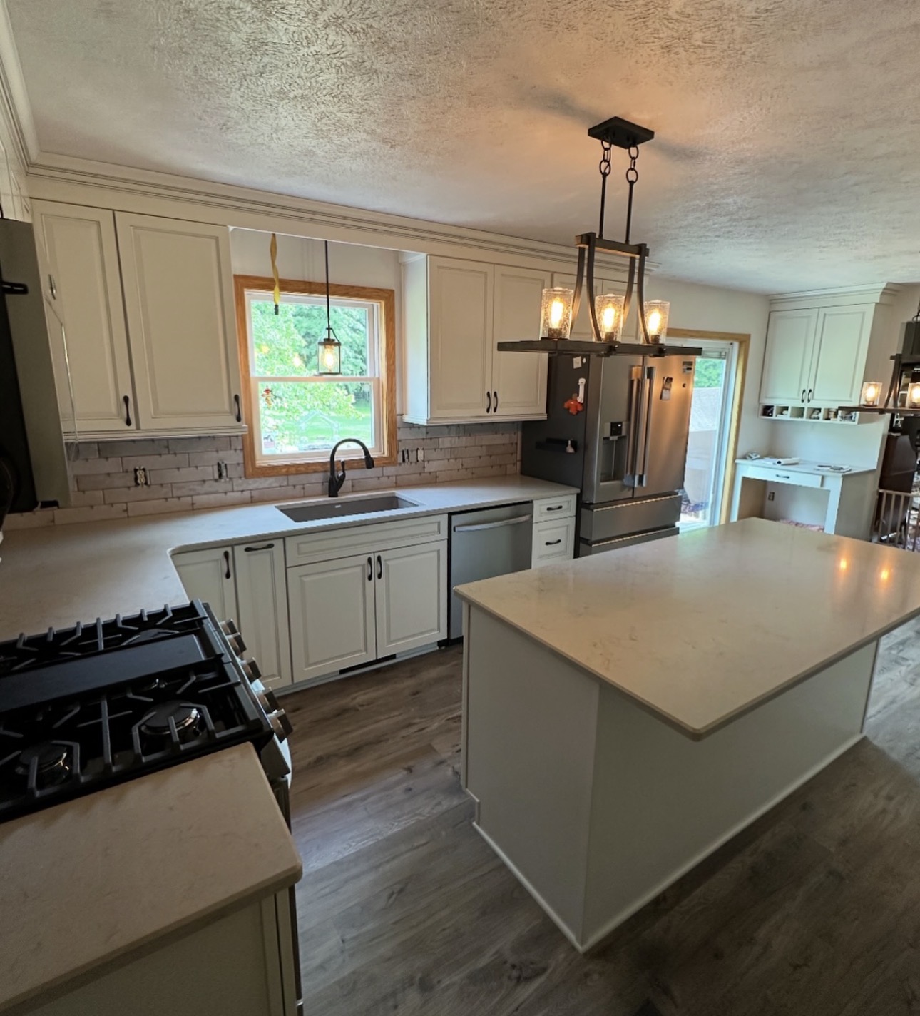 Kitchen renovation with shaker cabinetry, stone countertops, and hardwood floors in Northeast Ohio