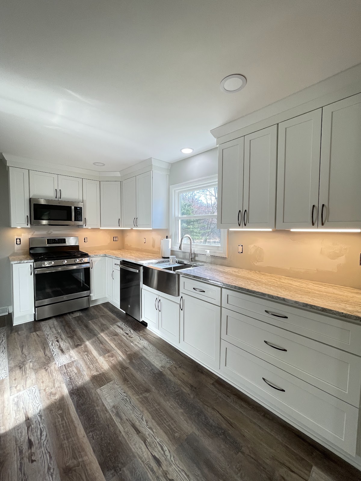 Full kitchen remodel with updated cabinets, stone countertops, and tile backsplash in Lake County Ohio