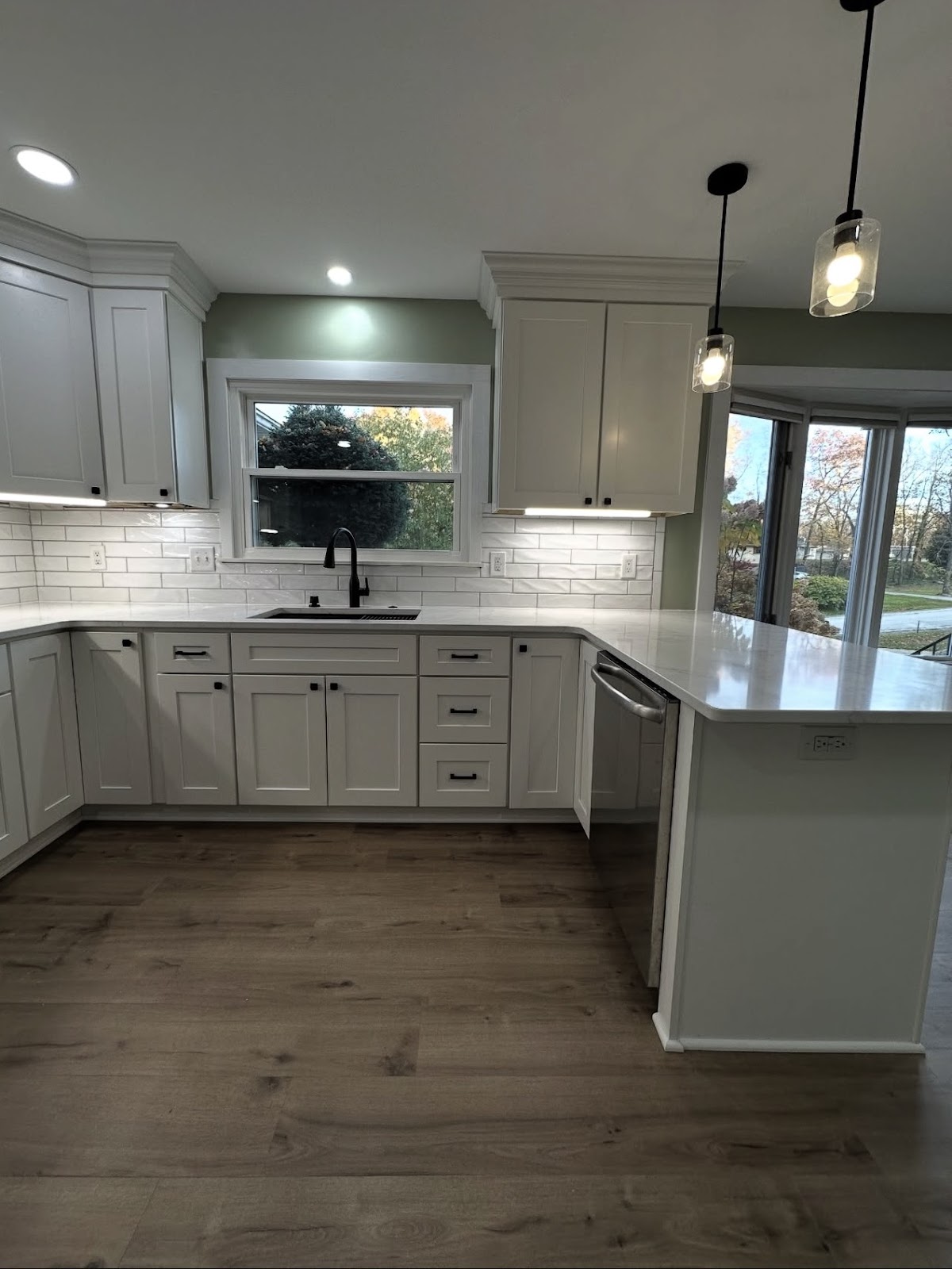 Kitchen remodel with custom shaker cabinets, stone countertops, and premium fixtures in Northeast Ohio
