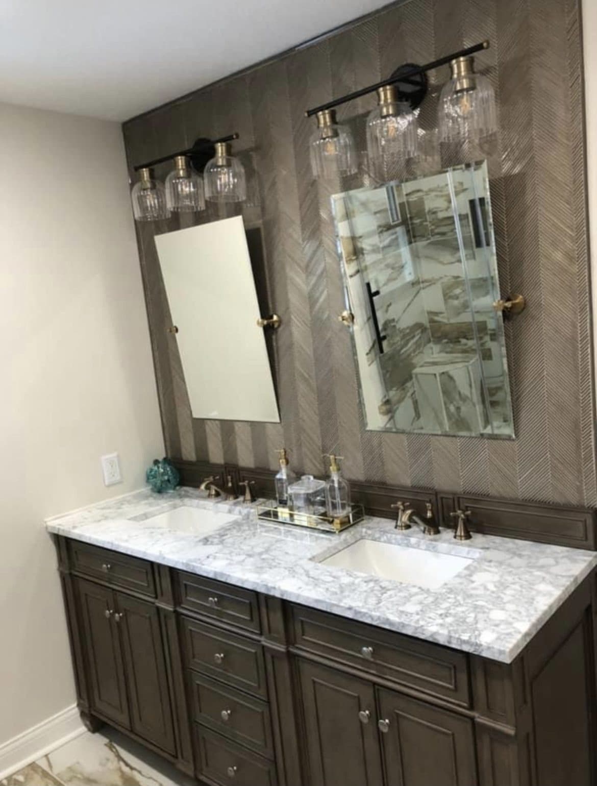 Master bathroom remodel with custom double vanity, dark gray cabinets, marble countertop, and herringbone wood accent wall in Northeast Ohio