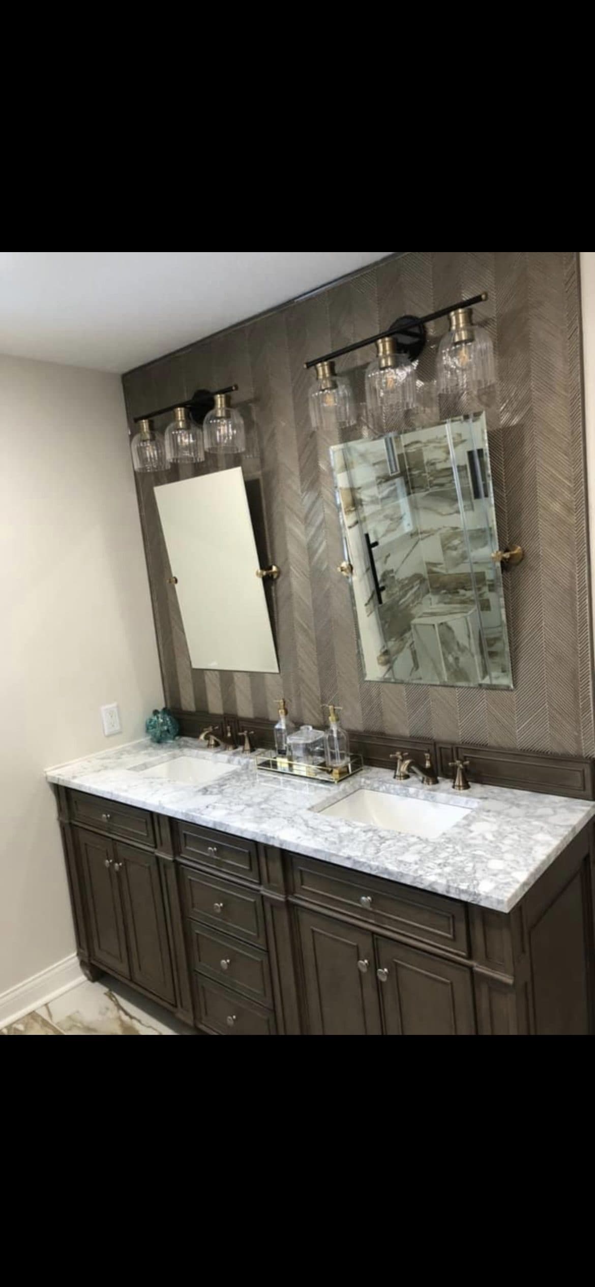 Master bathroom remodel with dark wood double vanity, marble countertop, and herringbone wood accent wall in Northeast Ohio