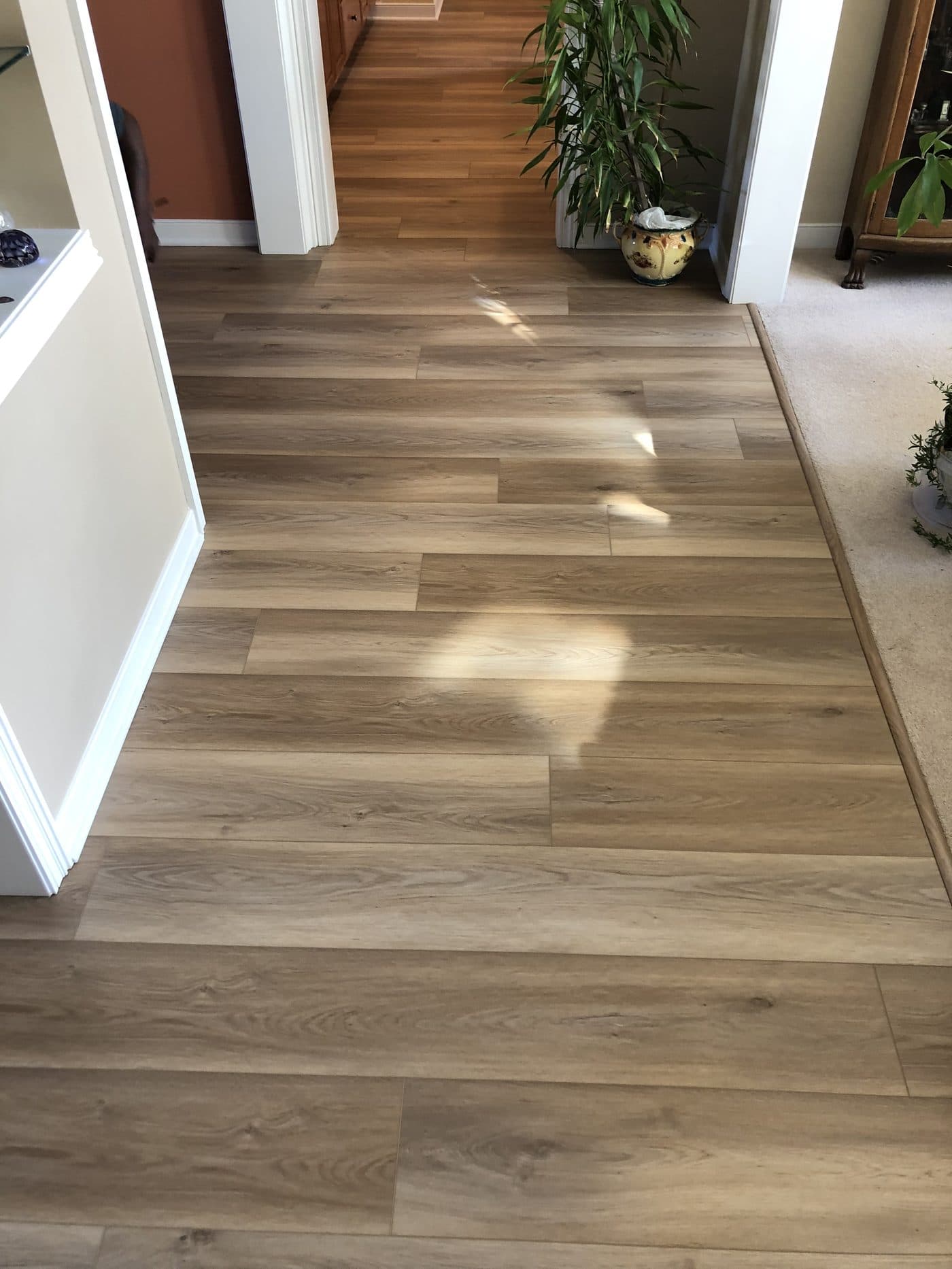 Light oak wide-plank luxury vinyl flooring installation in hallway in Northeast Ohio home