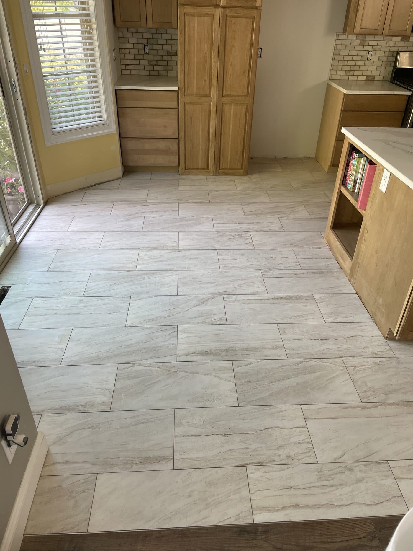 Light marble-look large-format tile flooring installation in Cuyahoga County home