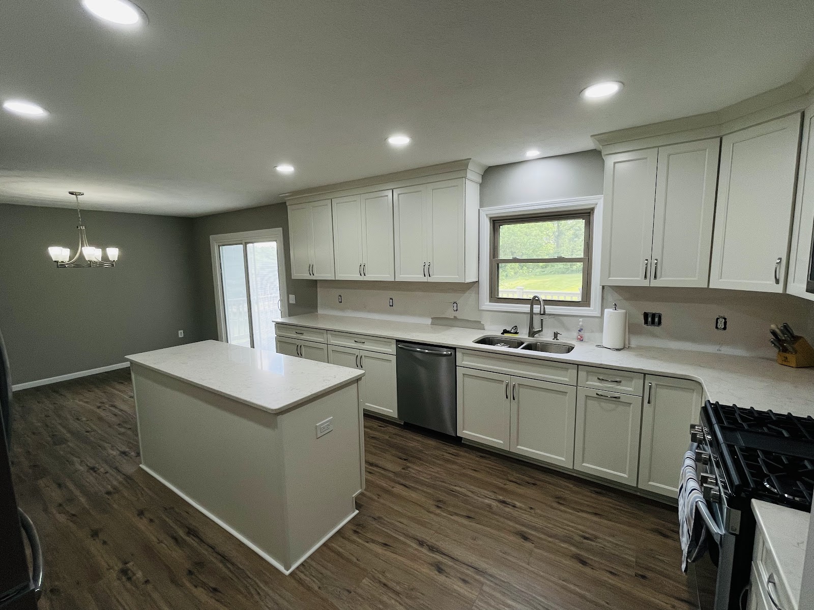 Full kitchen renovation with premium cabinetry, quartz island, and tile backsplash in Lake County Ohio