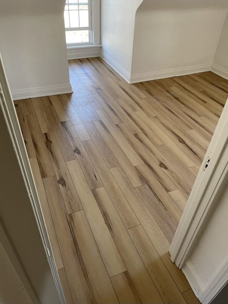 Light oak luxury vinyl plank flooring installation in hallway in Northeast Ohio home