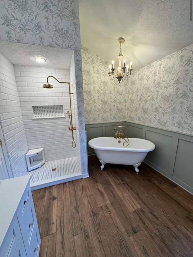 Elegant bathroom remodel with clawfoot tub and brass fixtures by Specialty Home Remodeling